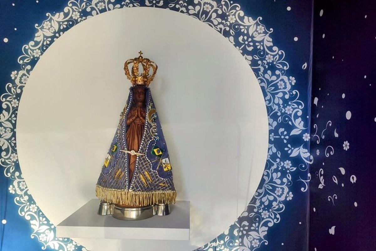 a clock with a crown on it in a mirror