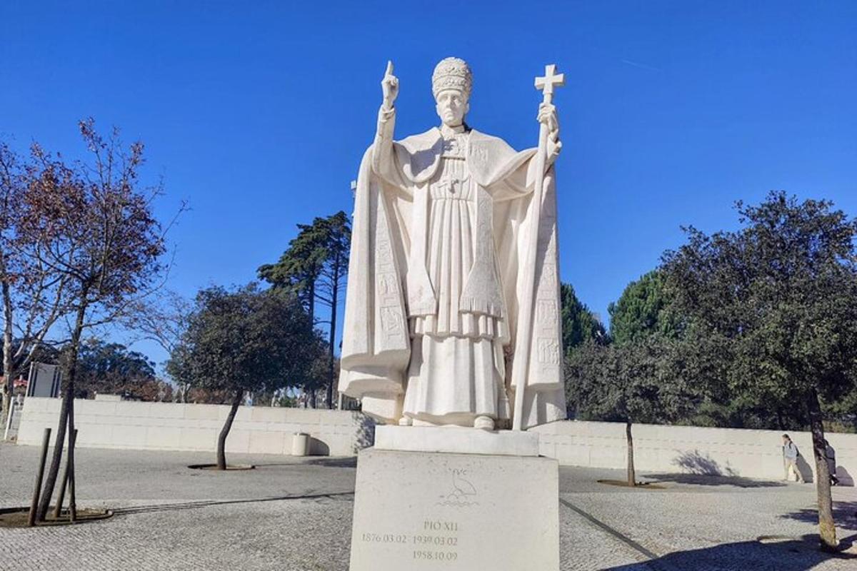 a statue of a man with his hands up
