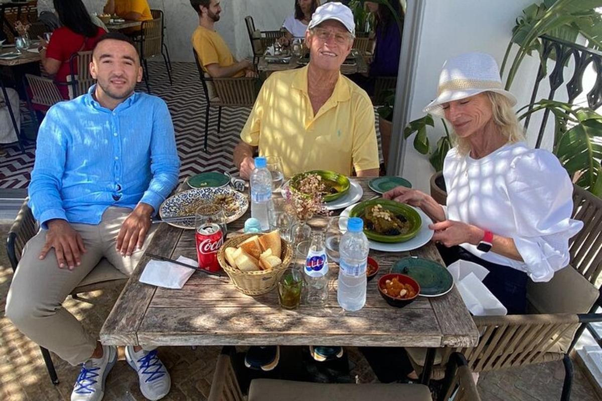 Un grupo de personas sentadas alrededor de una mesa con comida.