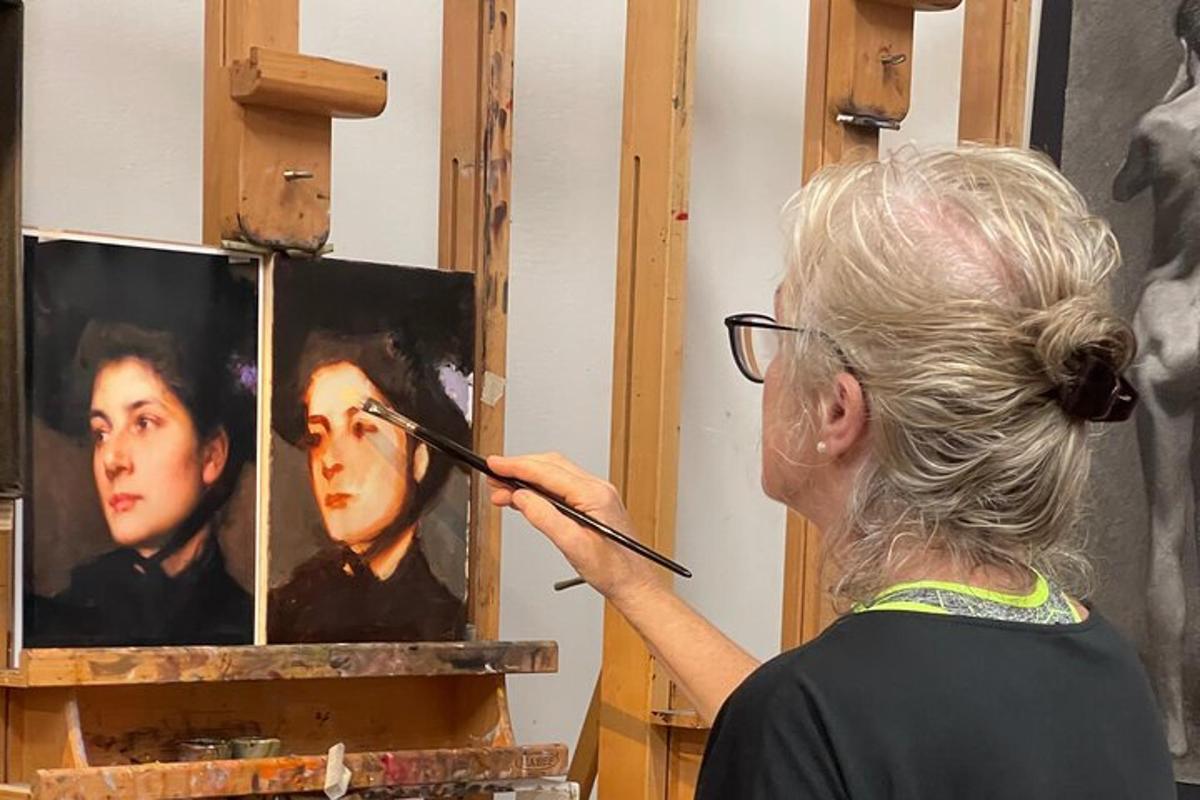 a woman painting a portrait of a woman