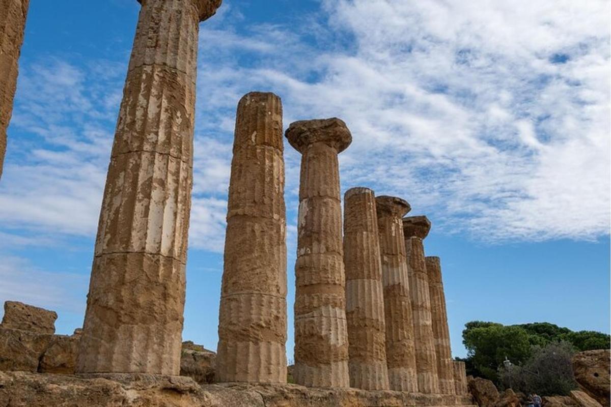 a group of ancient columns on a hill