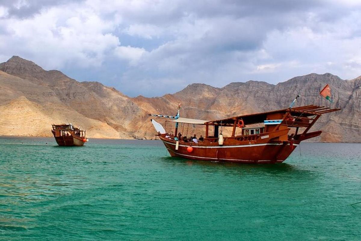 two boats in the water with mountains in the background