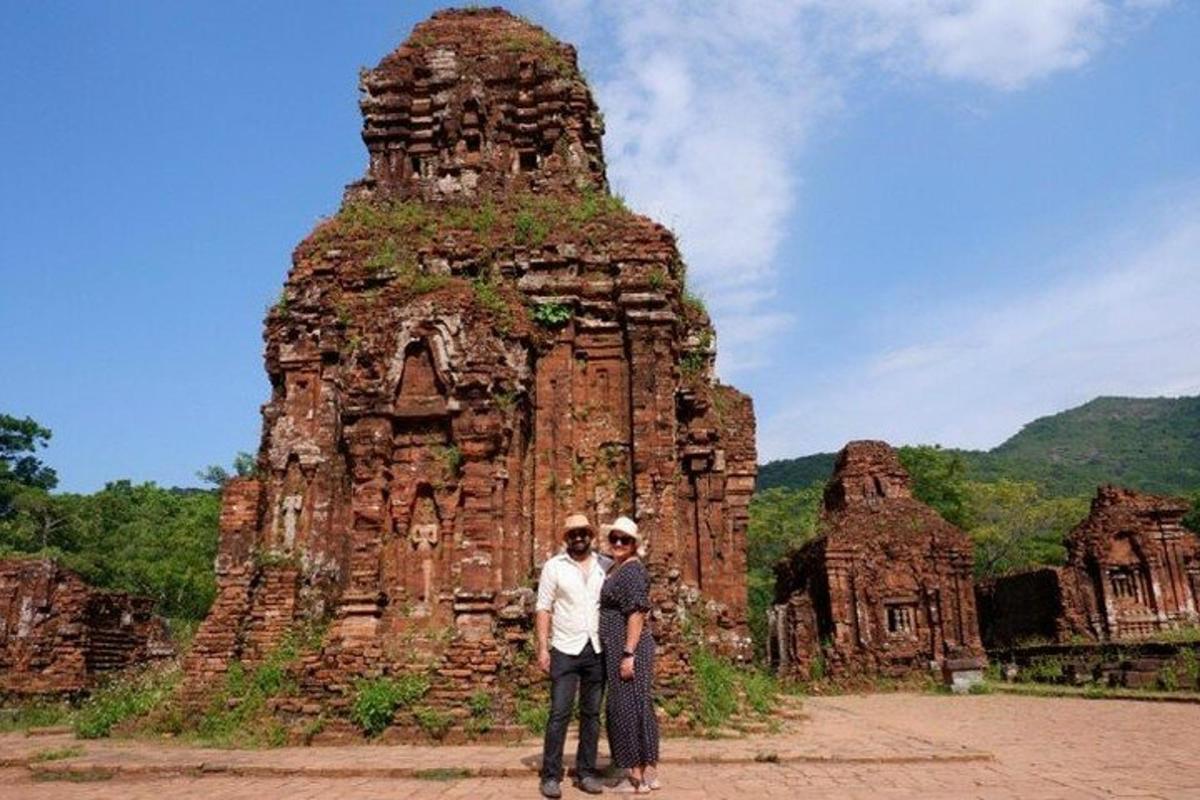 two people standing in front of a stone structure