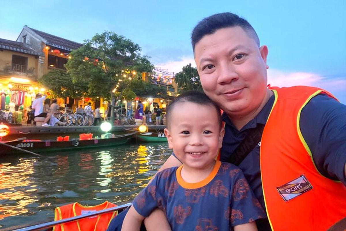 a man and a young boy in a boat on a canal