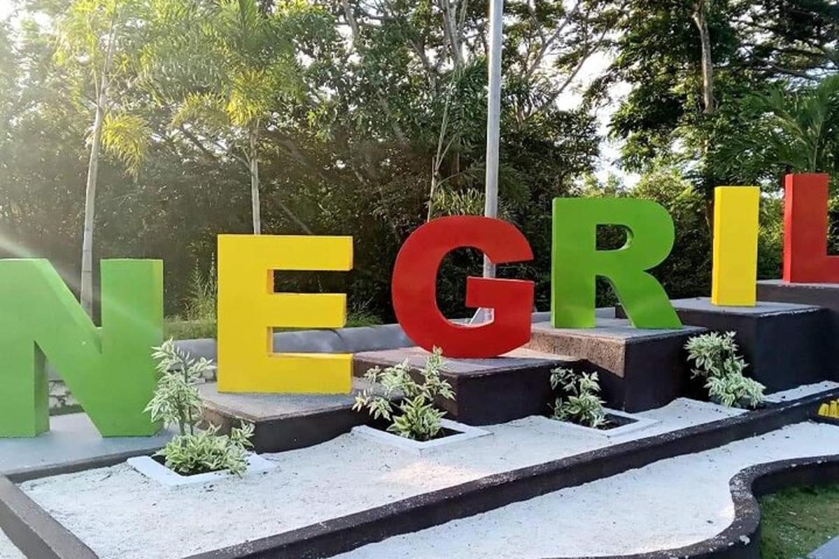 a large sign for a park with plants