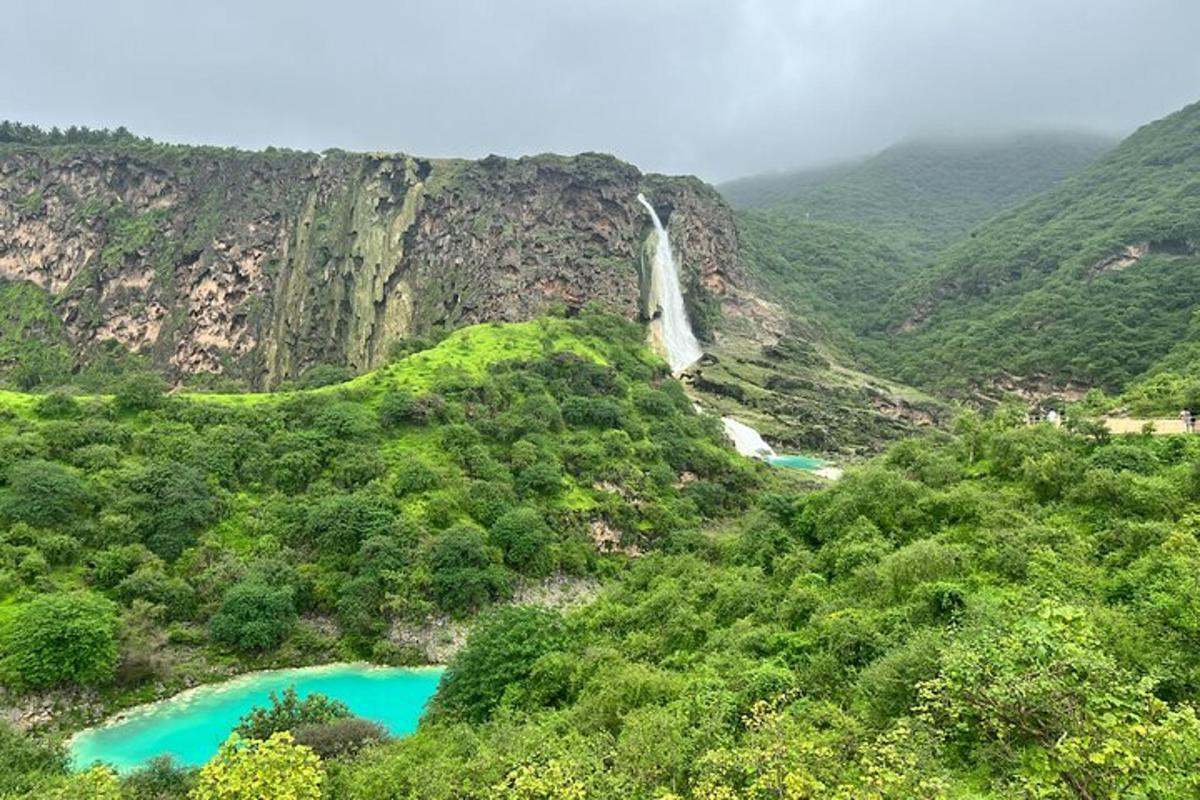 a waterfall on a mountain with two blue lakes