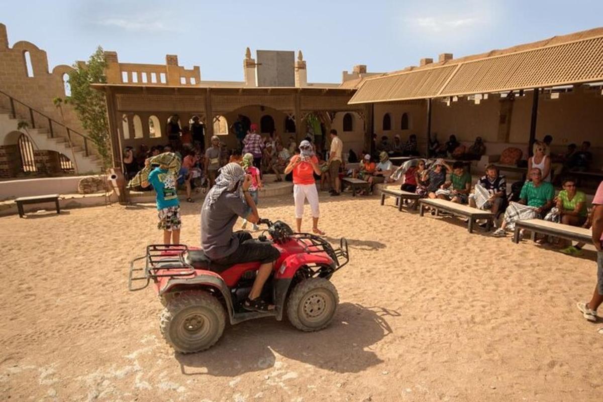 a man on a wheeler in the desert