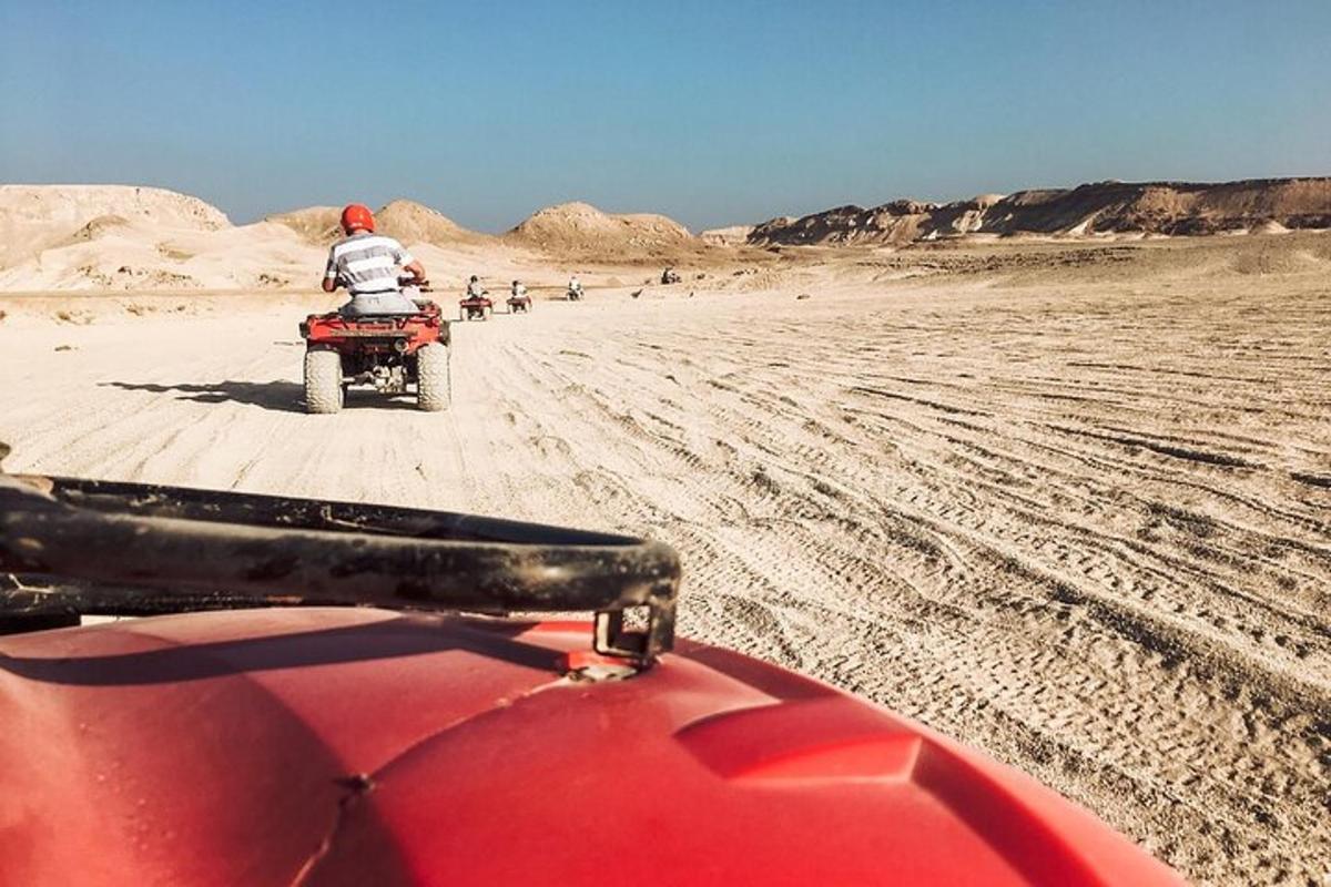 a person riding a motorcycle in the desert