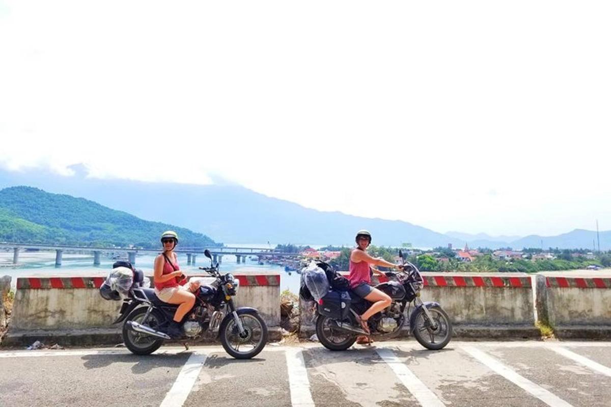 two people are riding motorcycles on a road