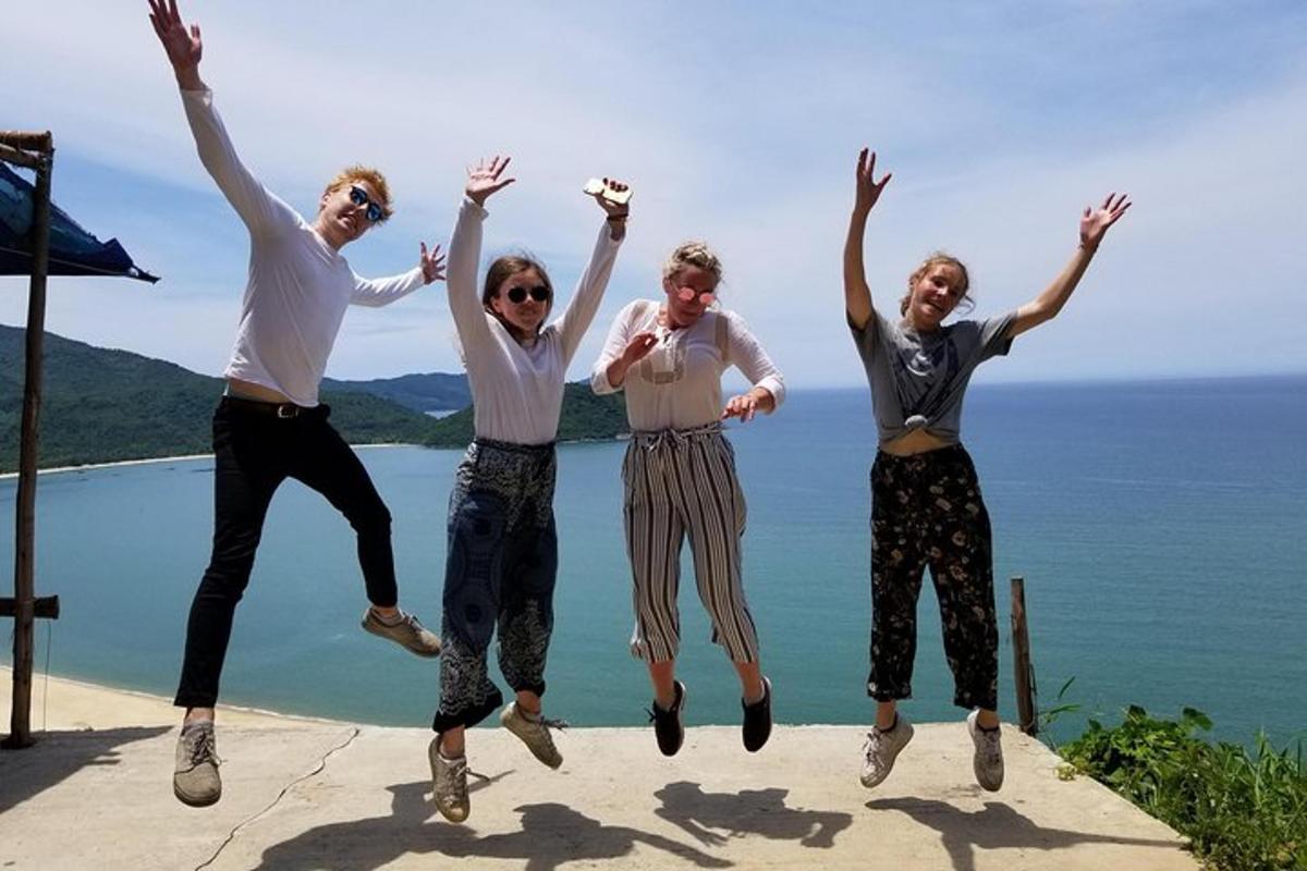 a group of people jumping in the air near the water