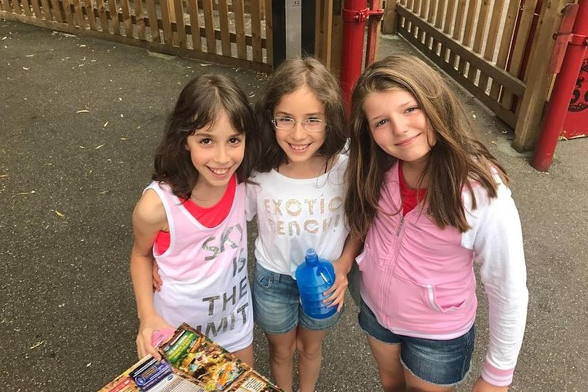 Tres chicas posan para una foto con una patineta