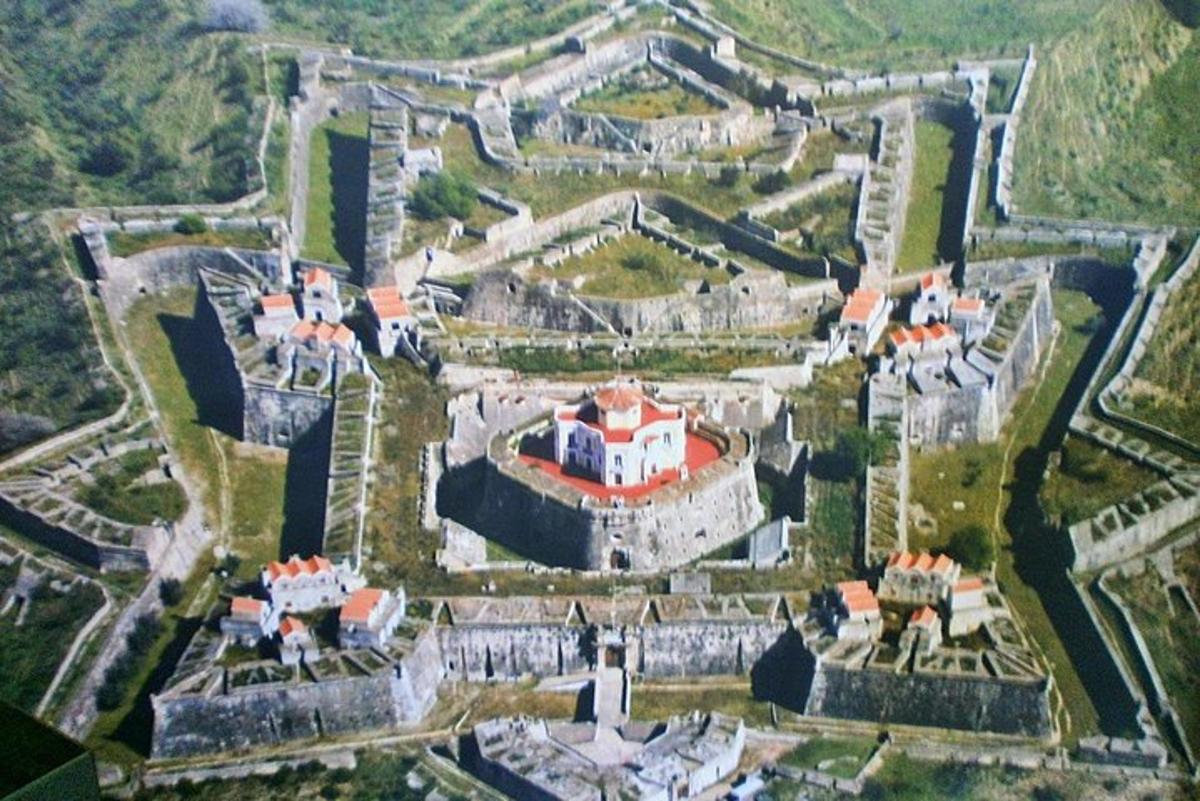 an aerial view of a castle with a red roof