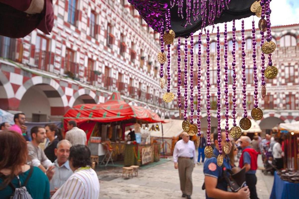 a group of people walking around an open market