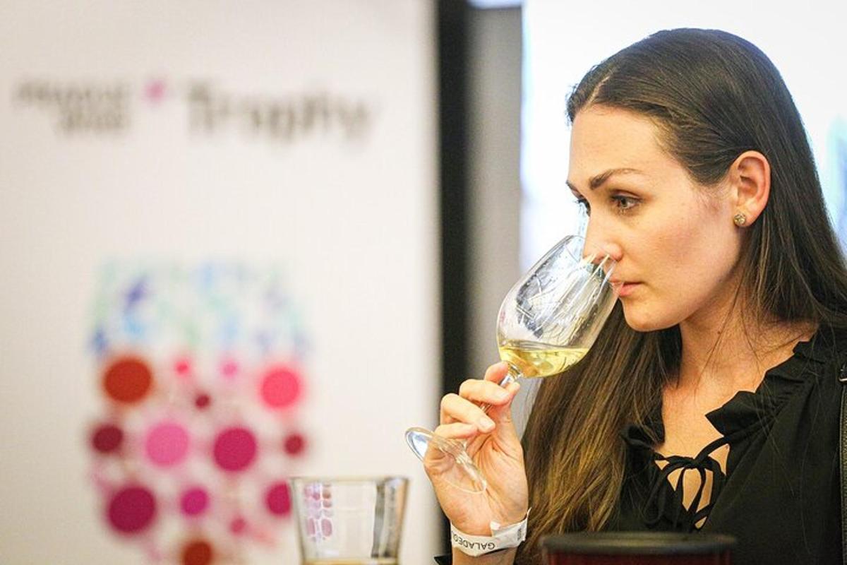 a woman drinking a glass of white wine