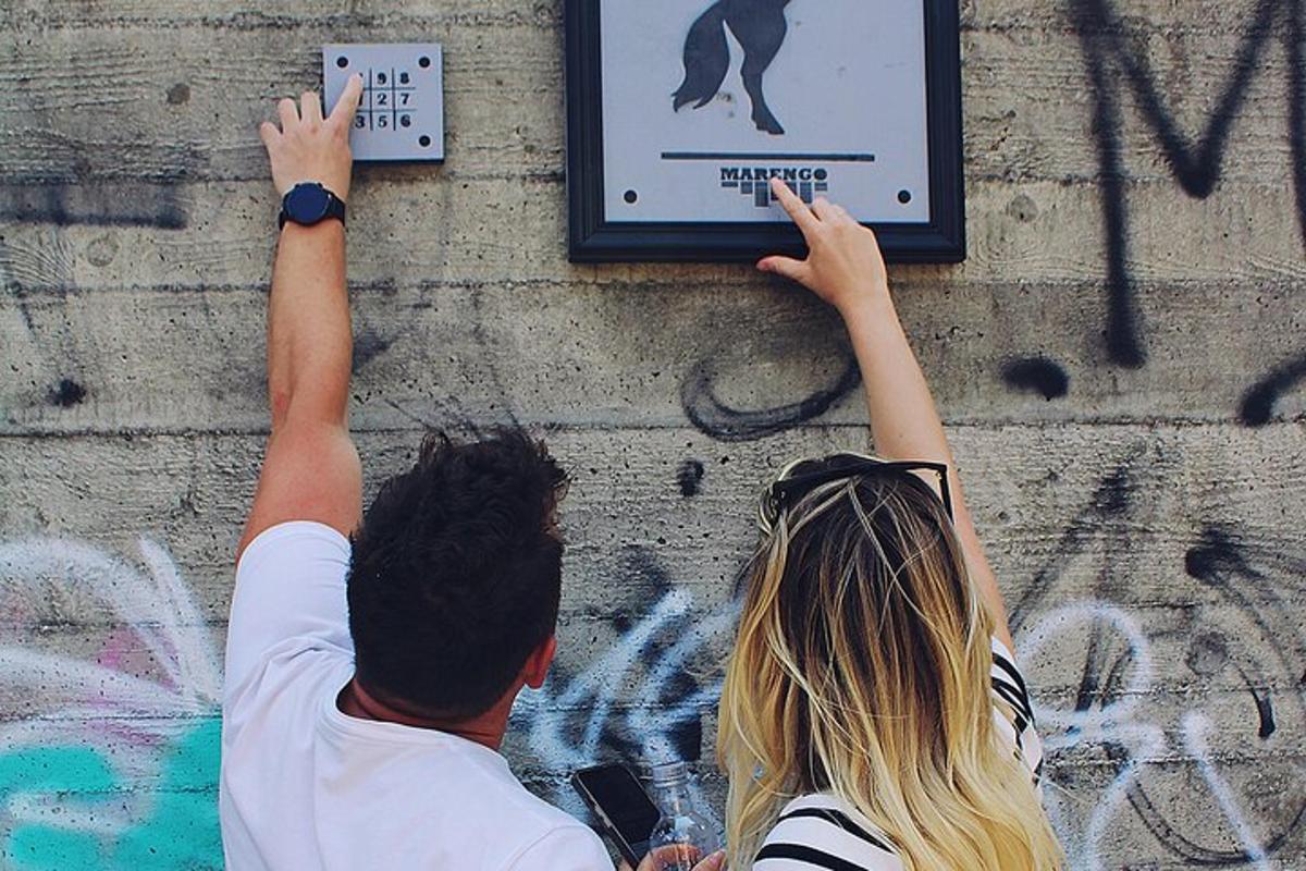 a man and a woman reaching for a sign on a wall