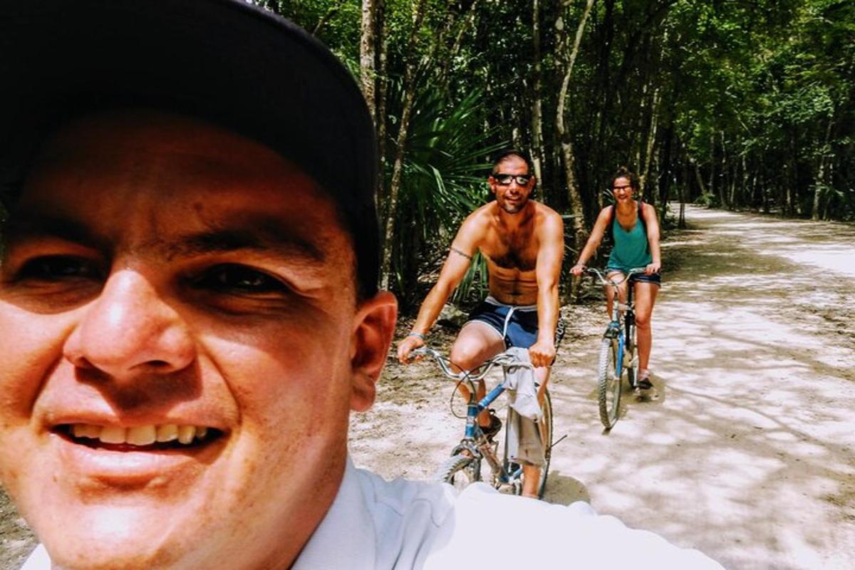 three men riding bikes down a dirt road