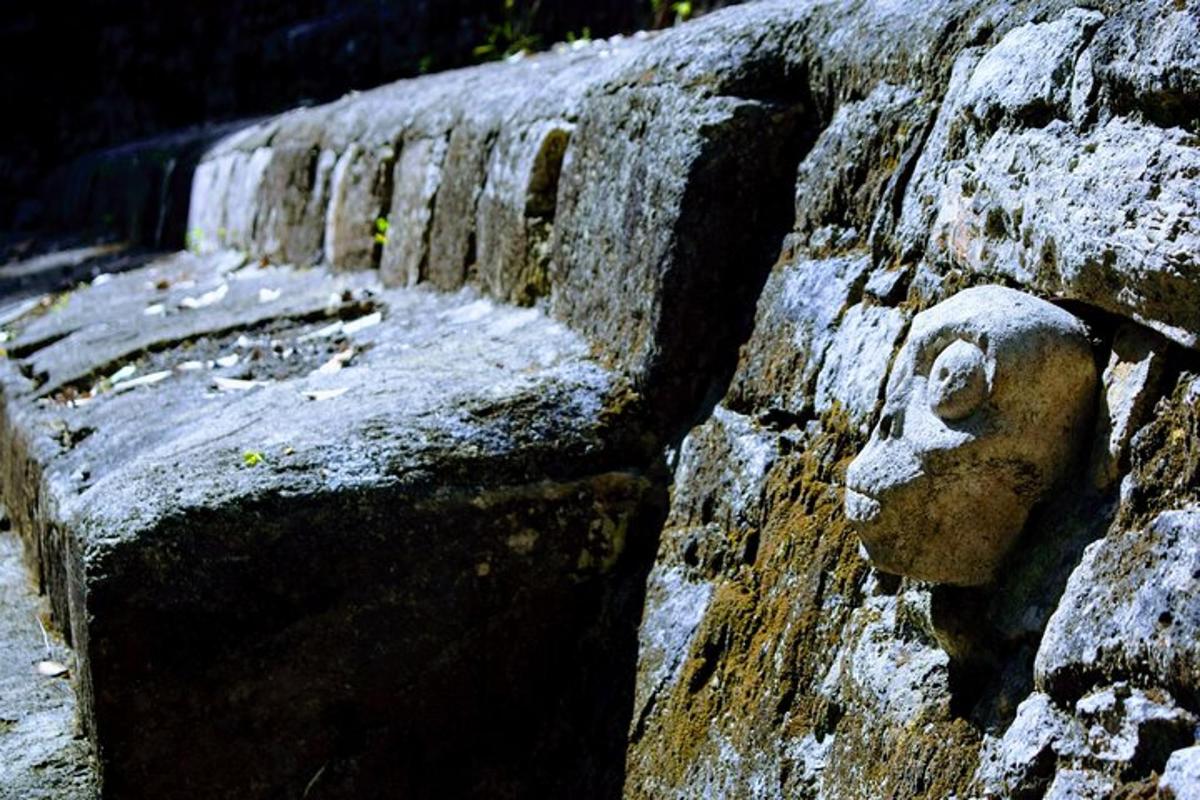 a stone wall with a face on it