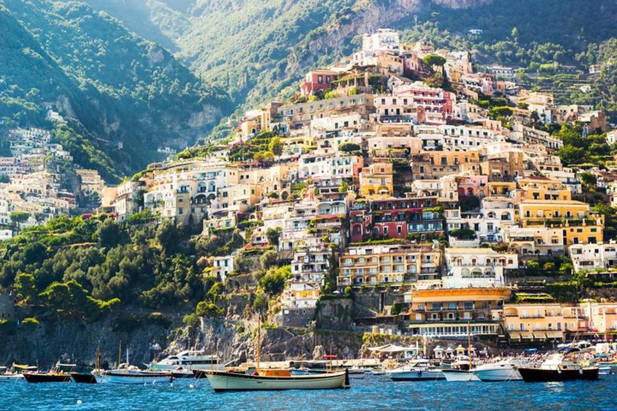 a town on a hill with boats in the water