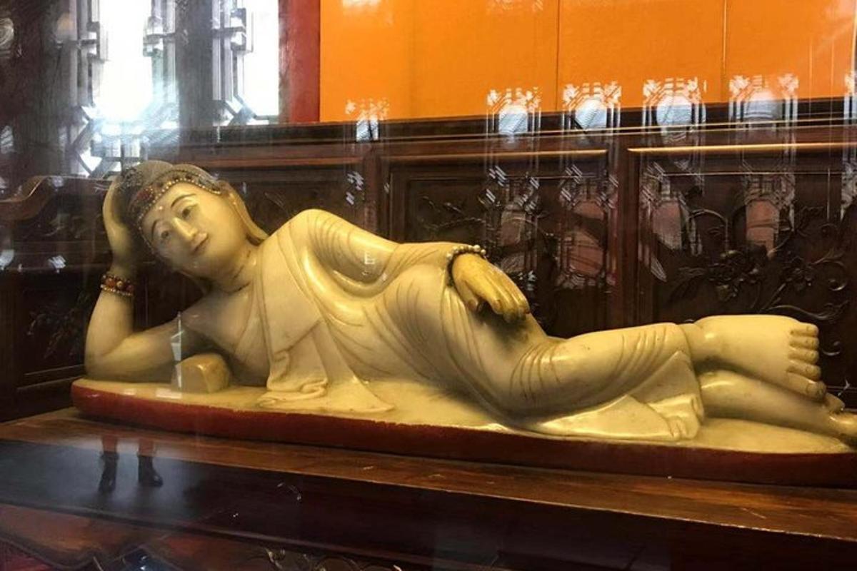 a statue of a woman laying down on a table