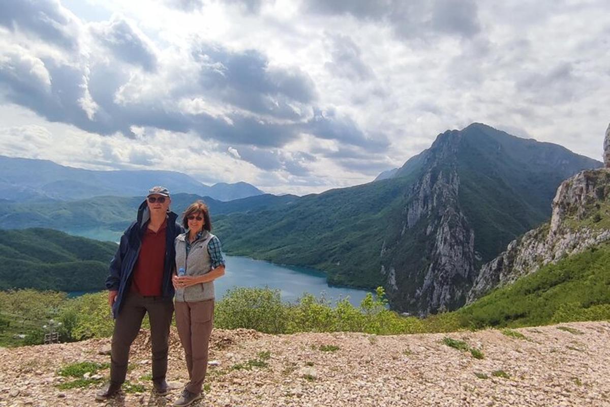 un uomo e una donna in piedi sulla cima di una montagna