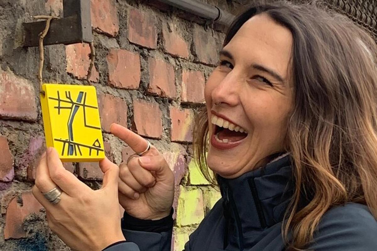 a woman is holding up a piece of paper