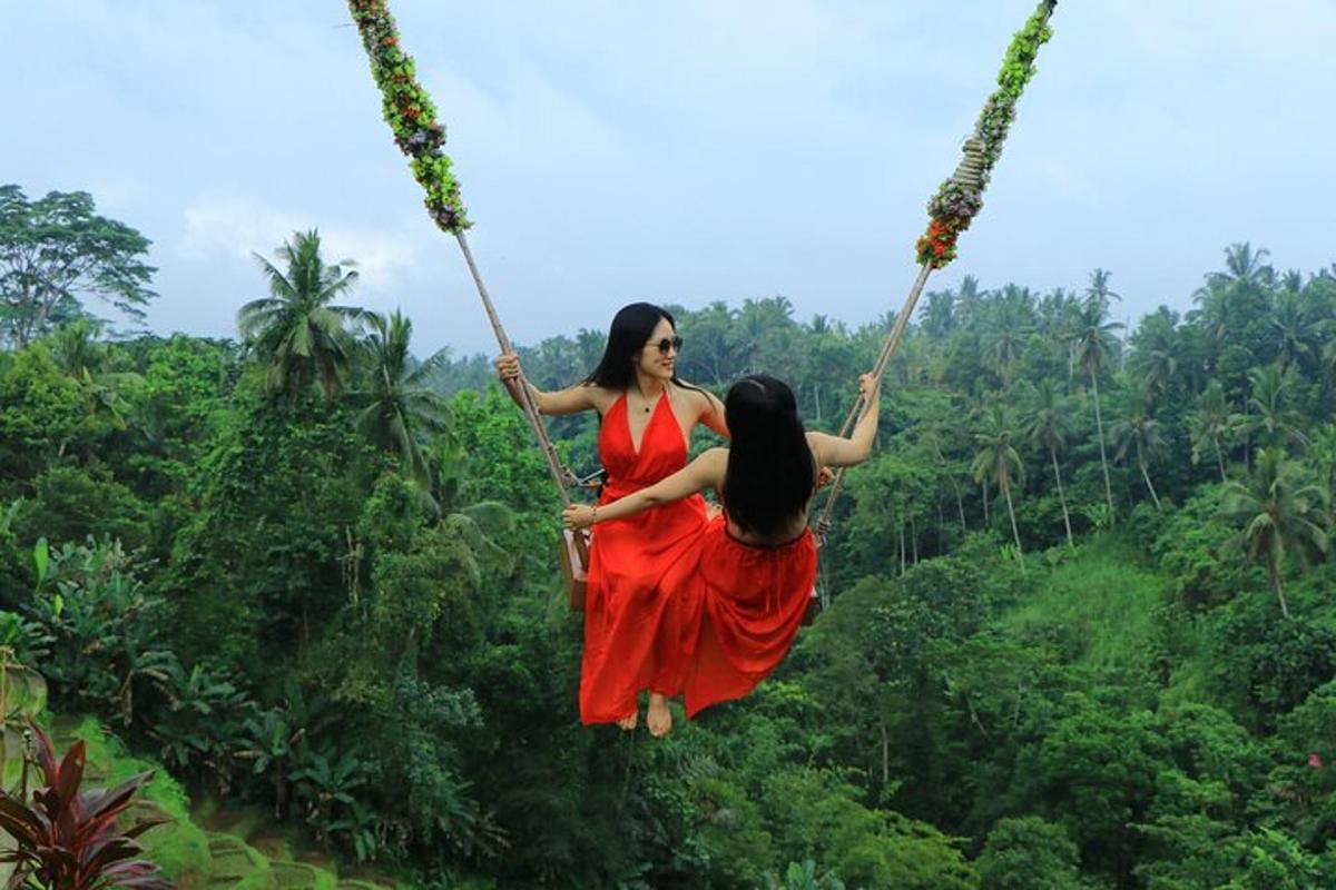 two women on a swing in the jungle