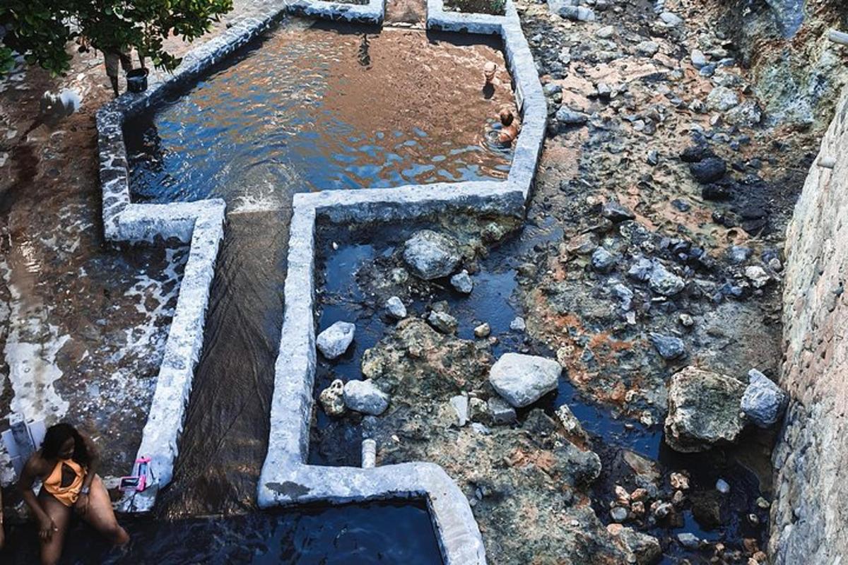 an aerial view of a pool of water with rocks