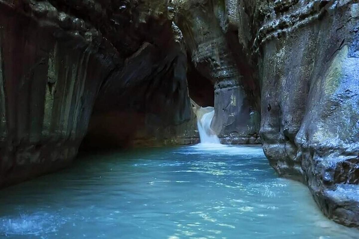 a river in a cave with a waterfall