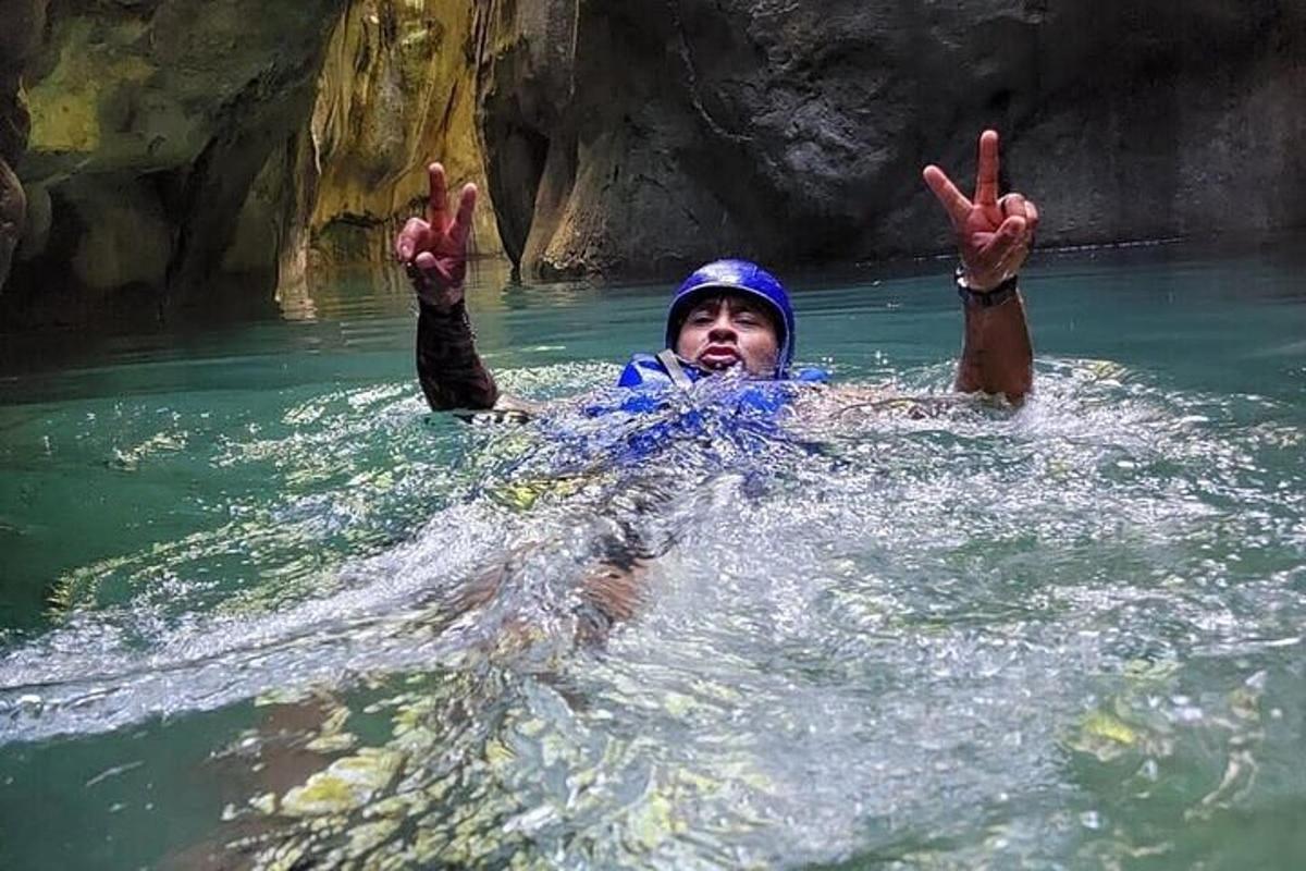 a man in the water with his hands in the water