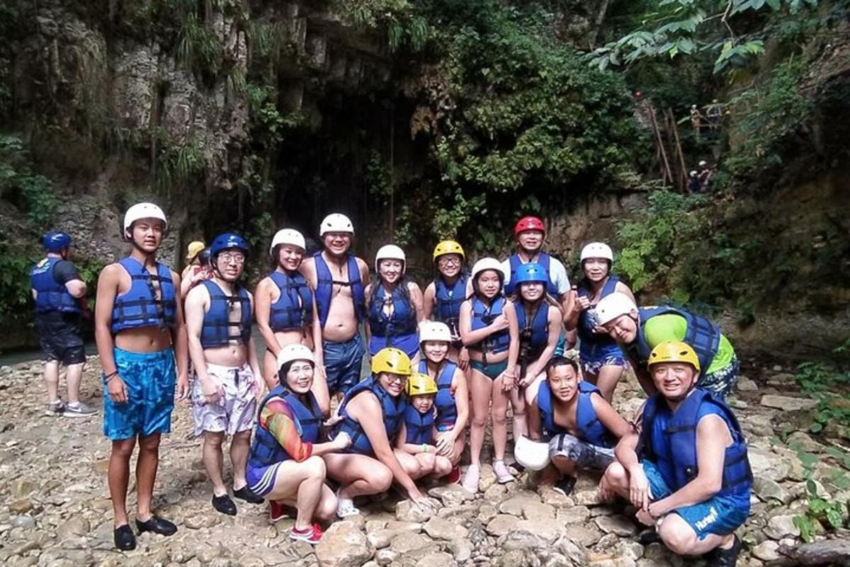 a group of people posing for a picture on a river