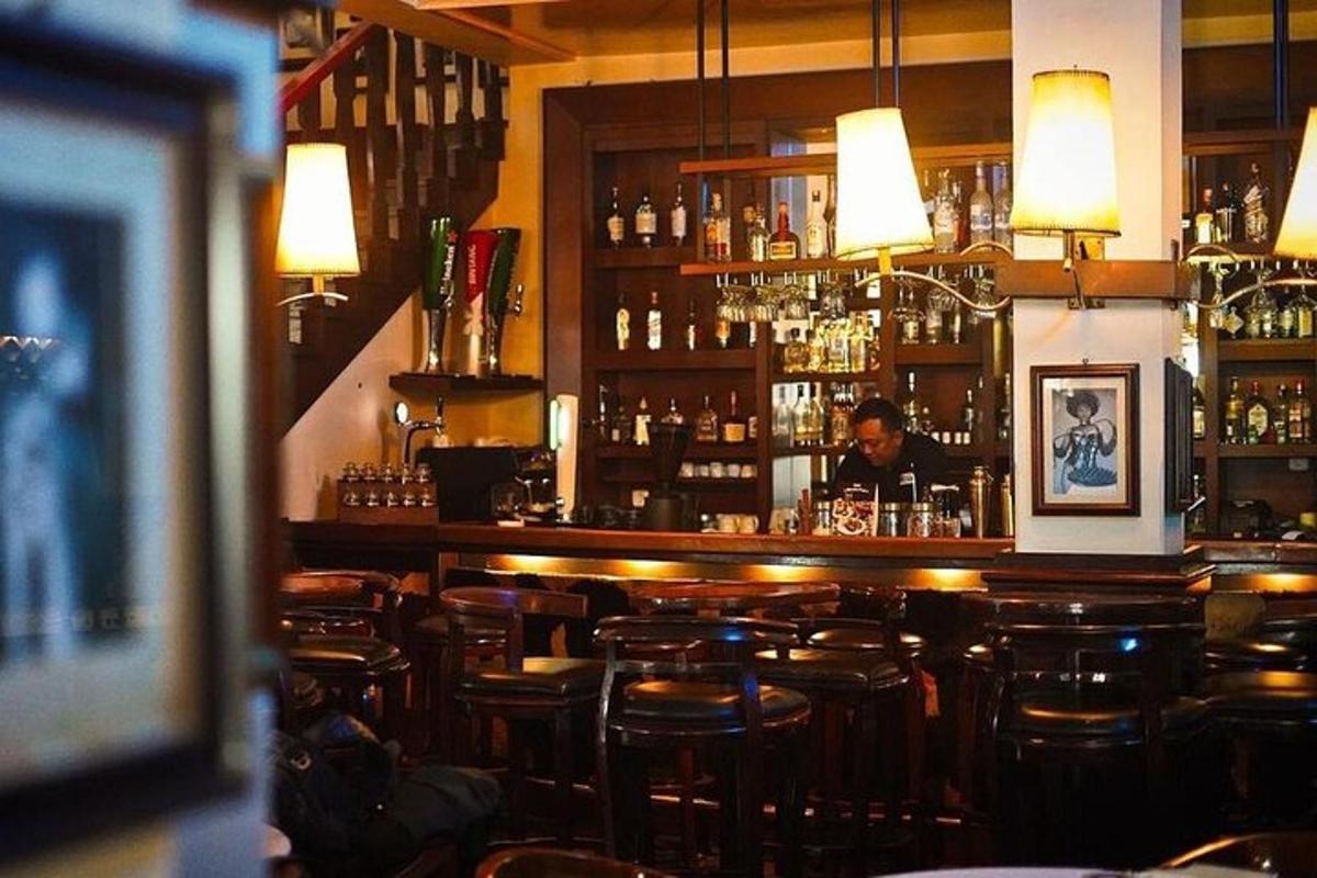 a bar with a man sitting behind the bar