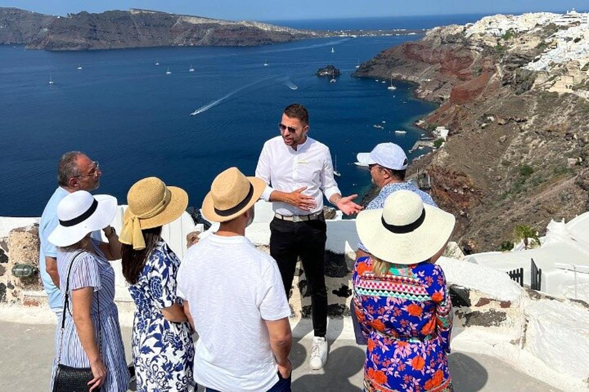 a group of people looking at a man standing on a ledge