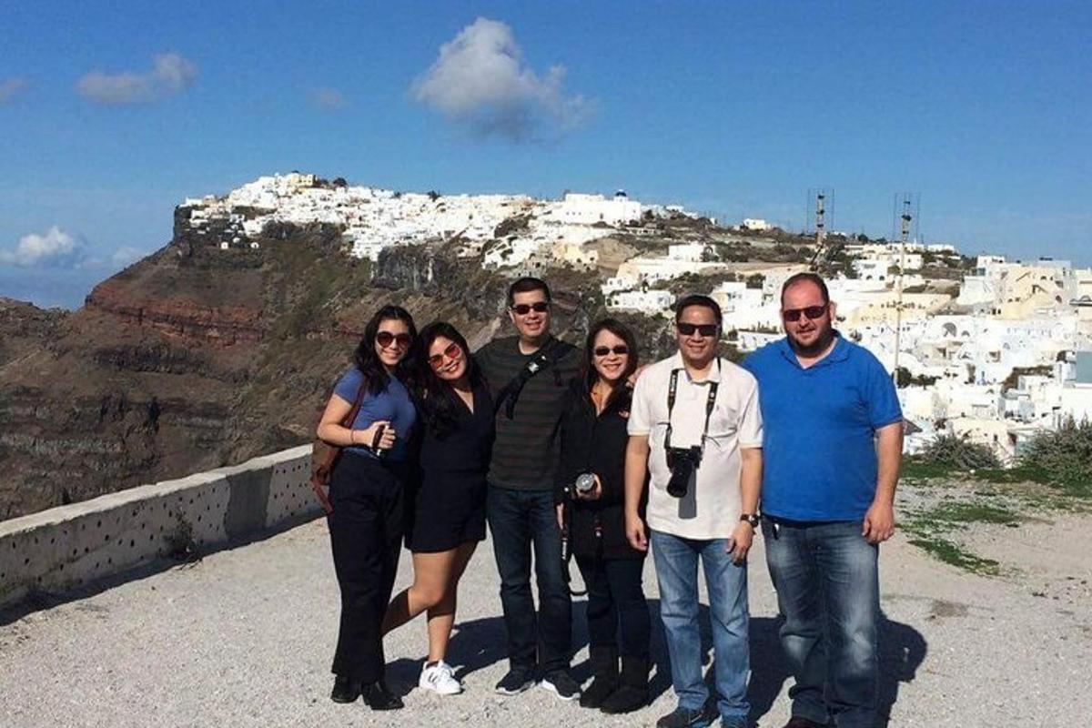 a group of people standing in front of a mountain