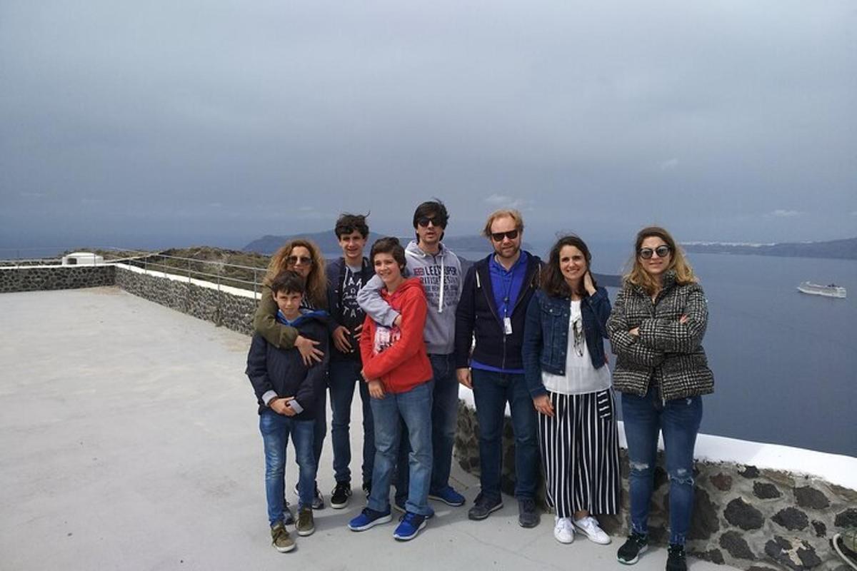 a group of people posing for a picture on a ledge
