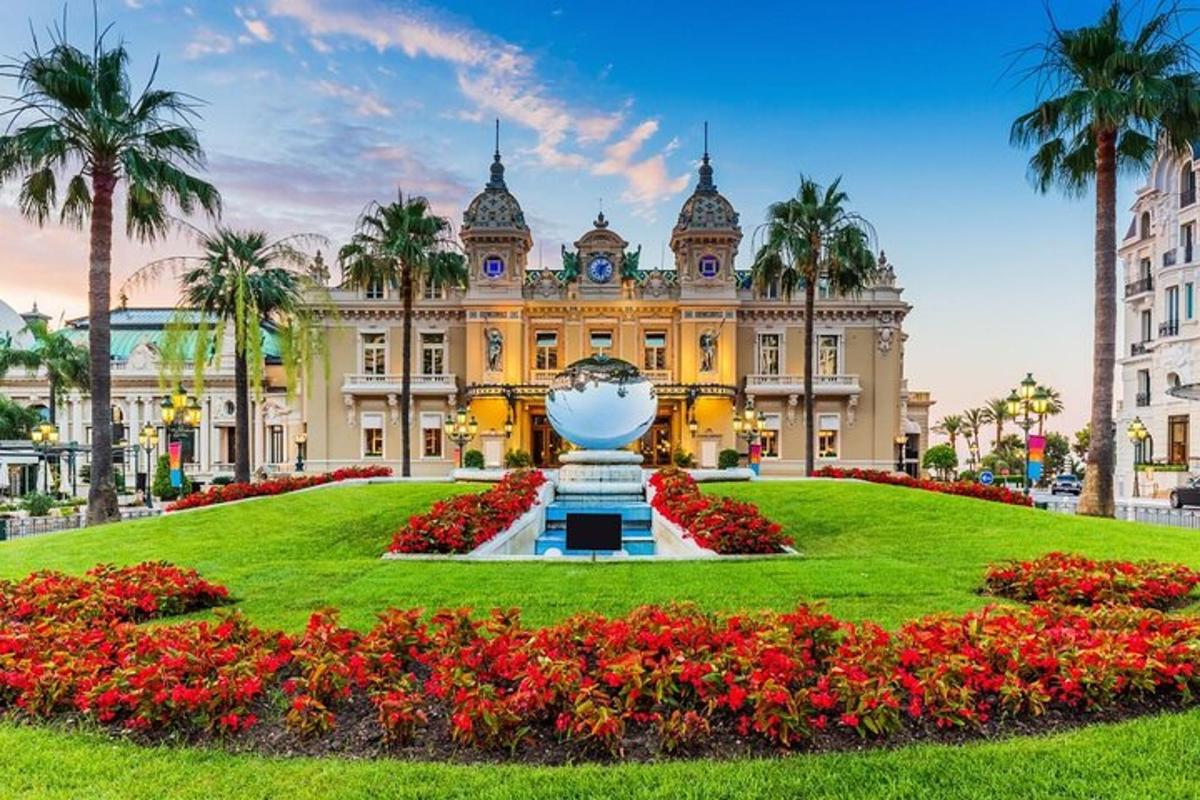 a building with a large flower garden in front of it