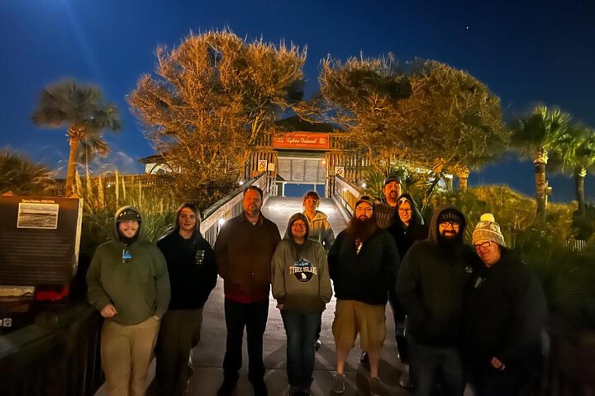 a group of people posing for a picture in front of a house