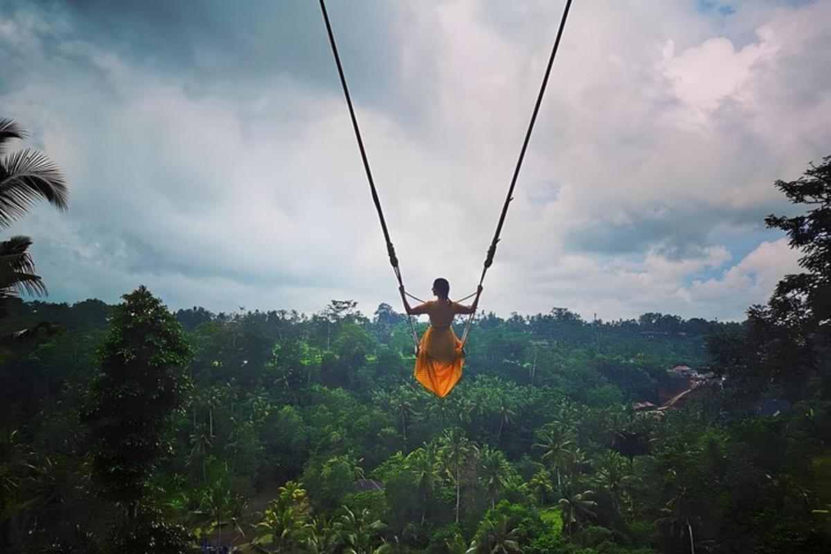 a man on a zip line over a forest