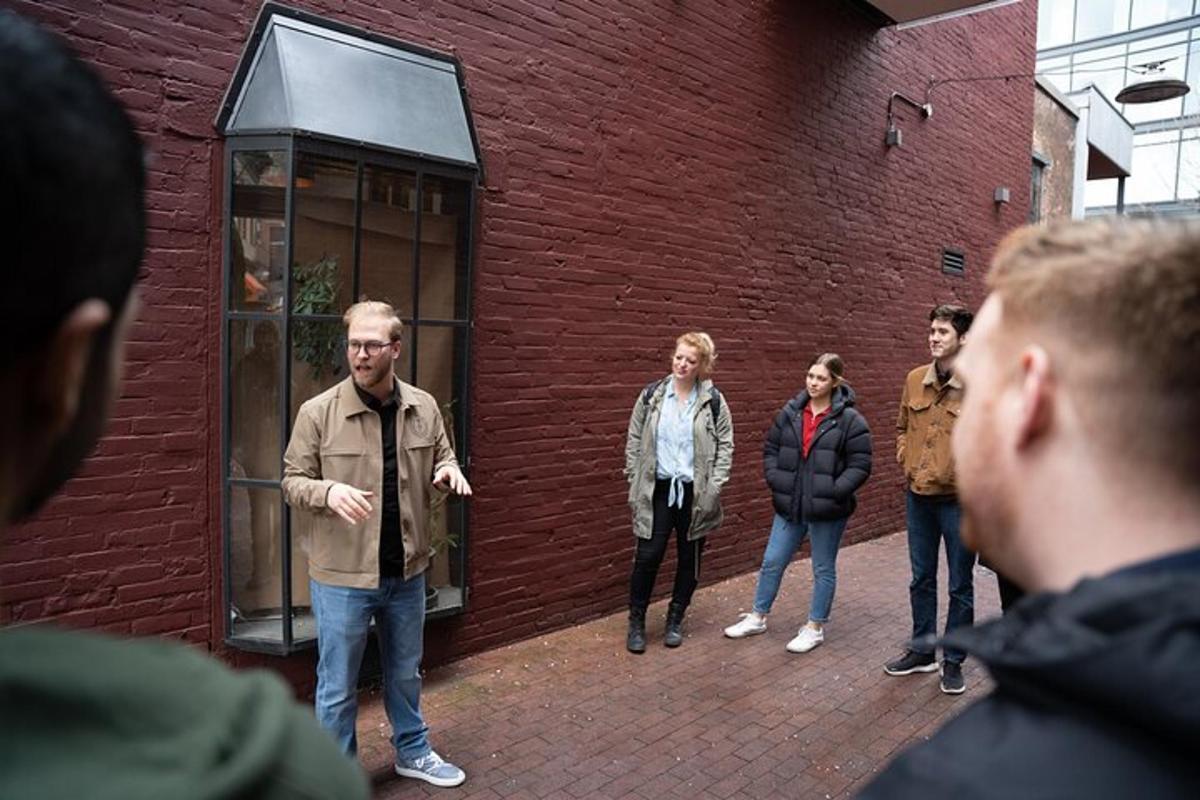 a group of people standing next to a red brick building