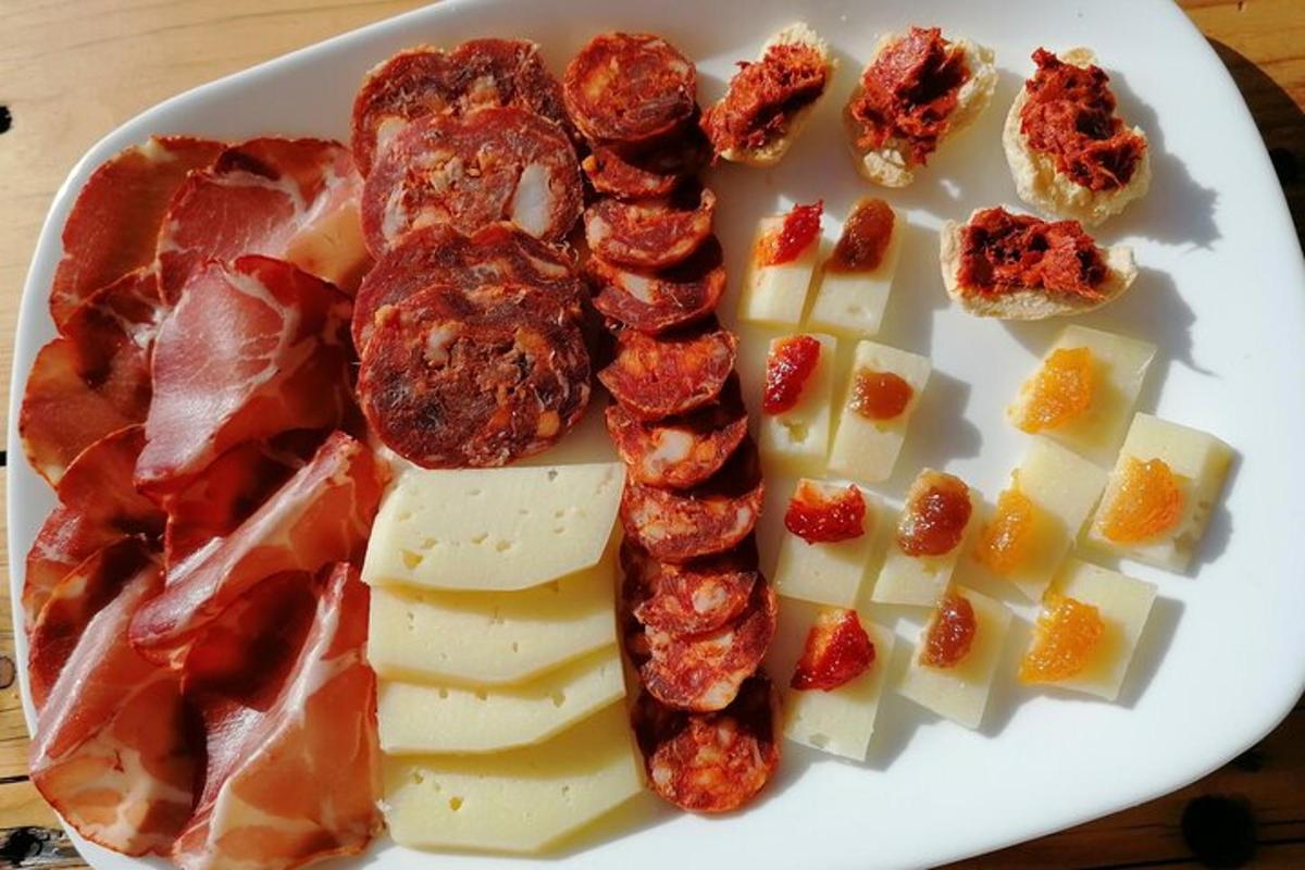 a plate of food with meat cheese and bacon