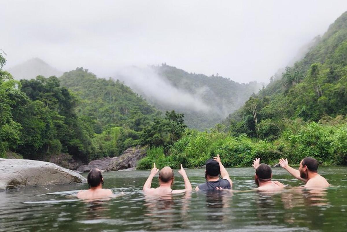 a group of people in the water in a river