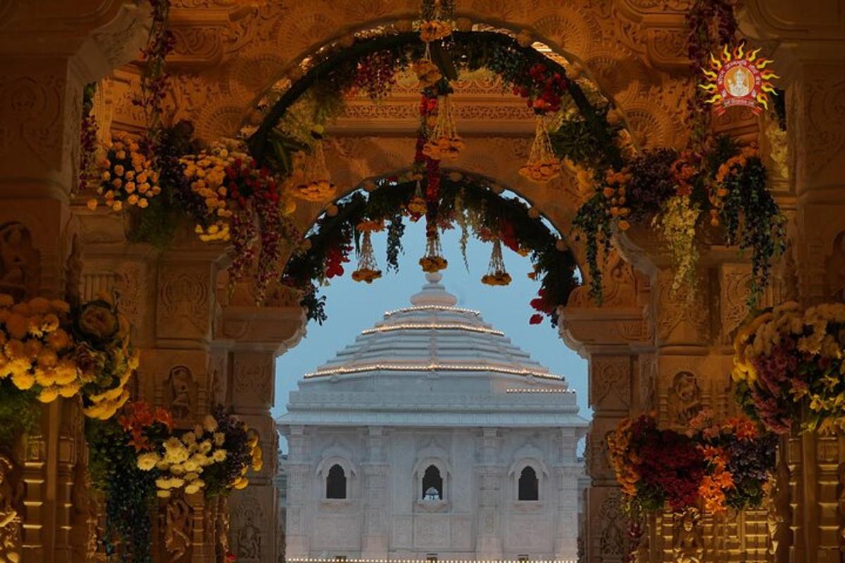 a building with an arch in a room with flowers