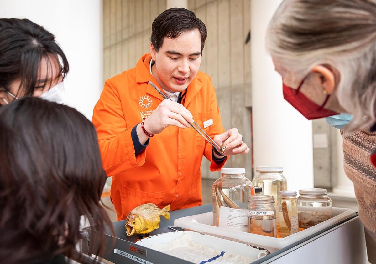 a woman and a man preparing food in a laboratory
