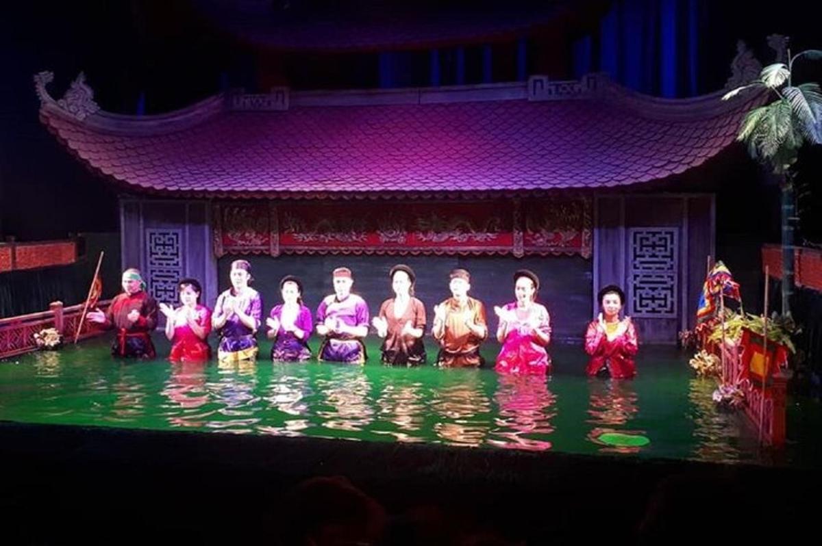 a group of people sitting in the water on a stage