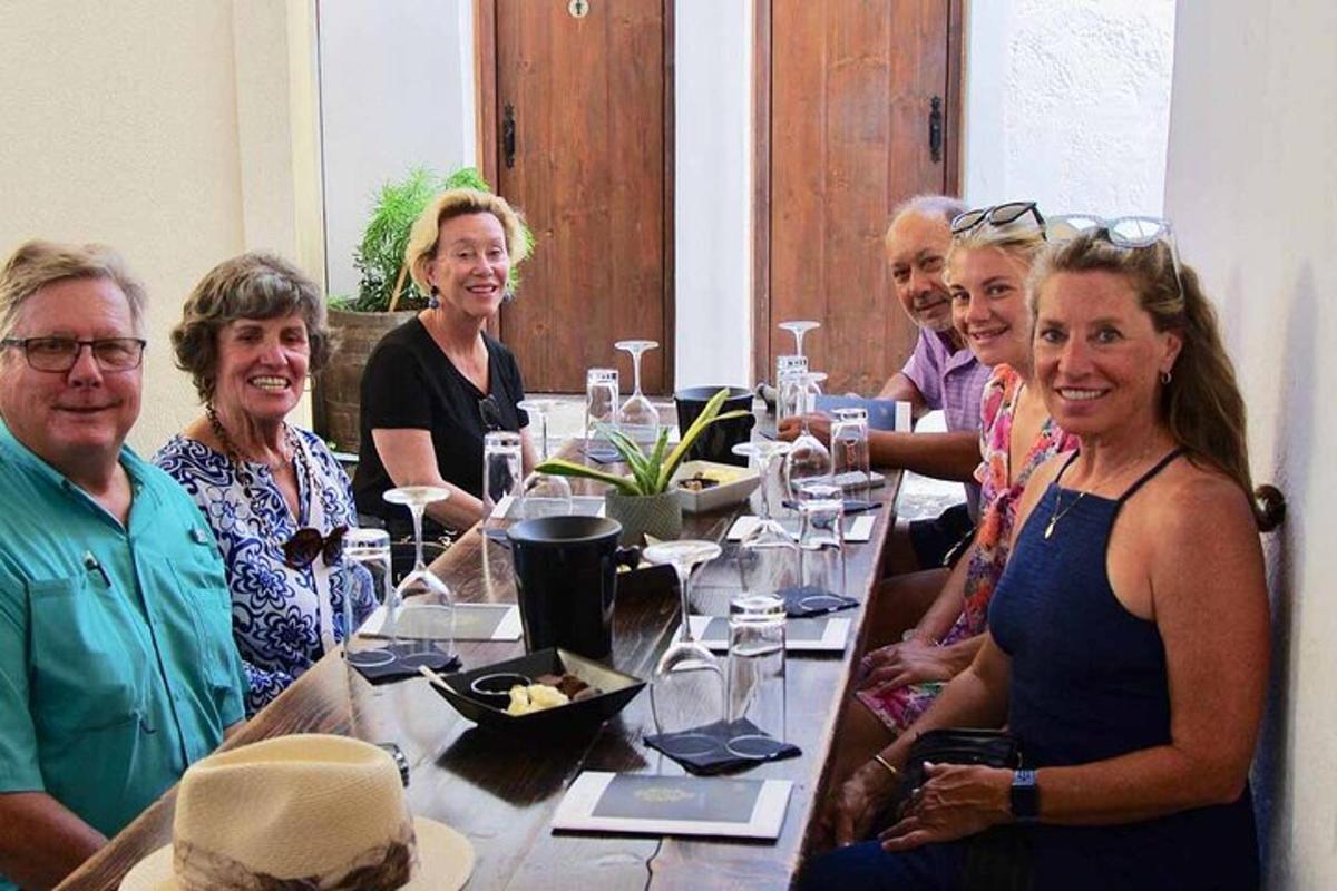a group of people sitting around a long table