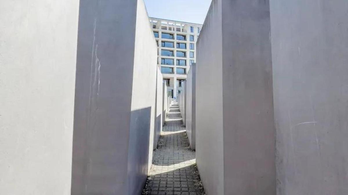a hallway of a building with a building in the background