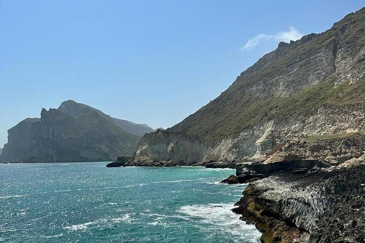 a large body of water with mountains in the background