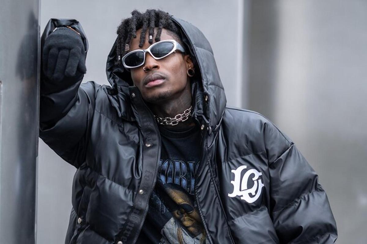 a man wearing sunglasses and a leather jacket