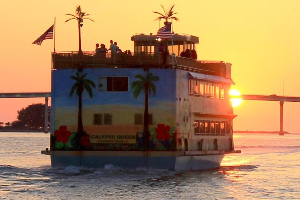 a ferry boat in the water at sunset