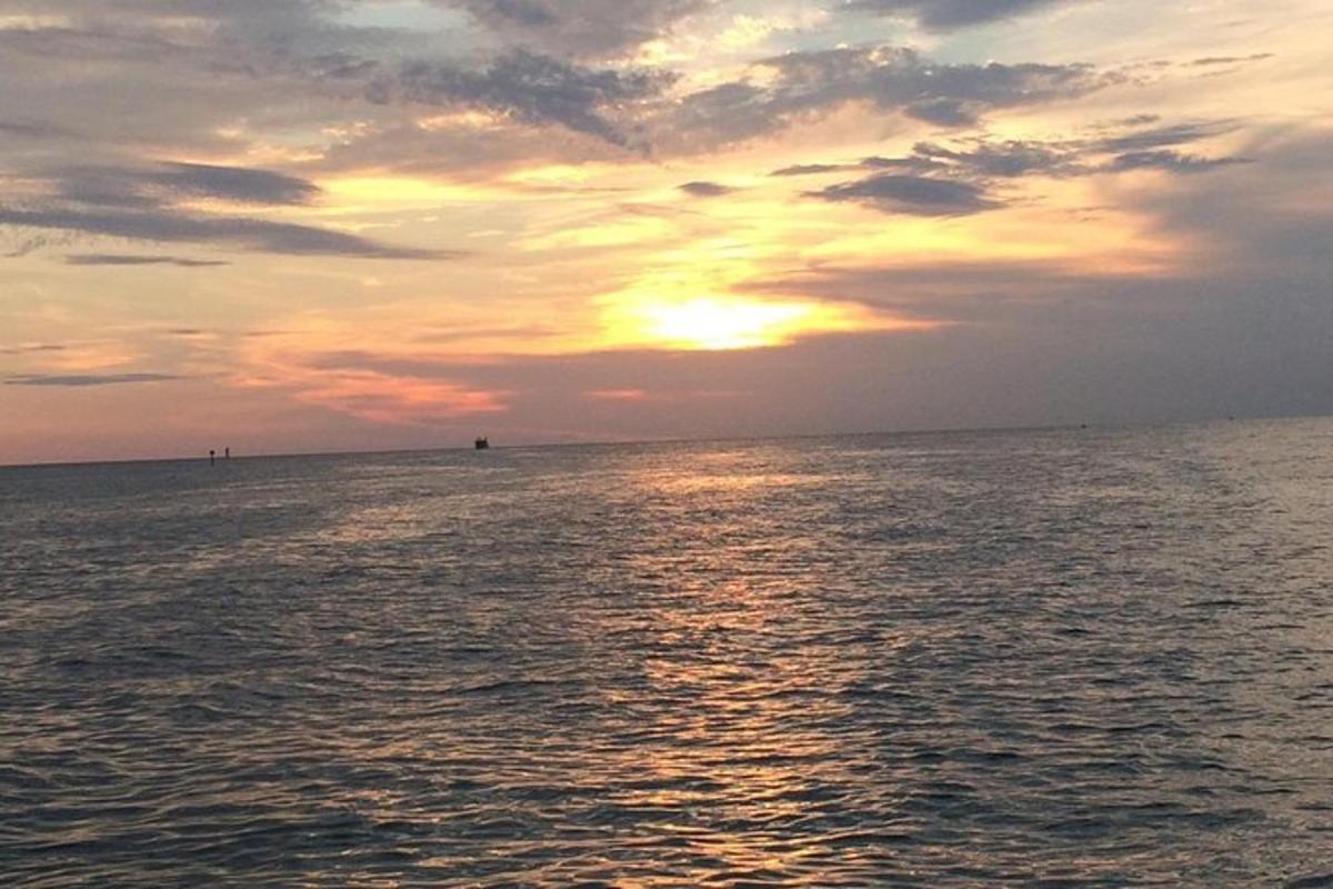 a sunset over the ocean with the sun setting
