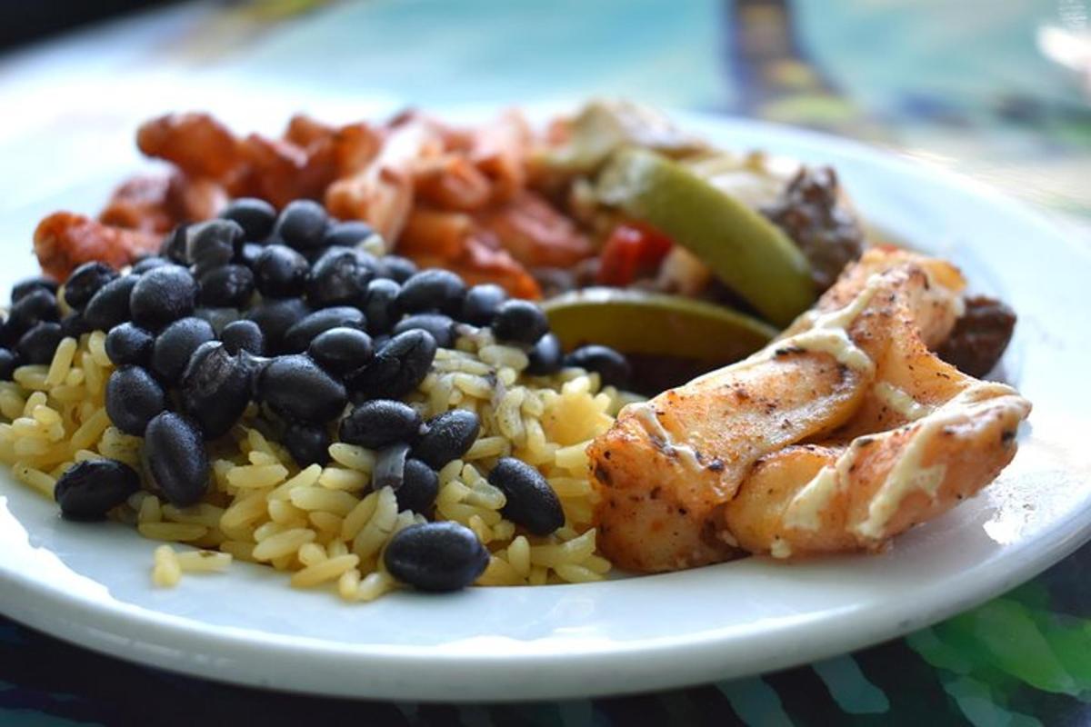 a plate of food with beans and chicken and rice